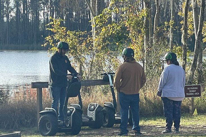 Guests learning watching a Segway demonstration from their guide. 